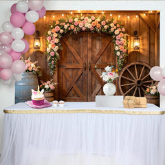 Lofaris Rustic Barn Wooden Door Floral Arch Photography Backdrop with String Lights and Wagon Wheel, Elegant Event Background